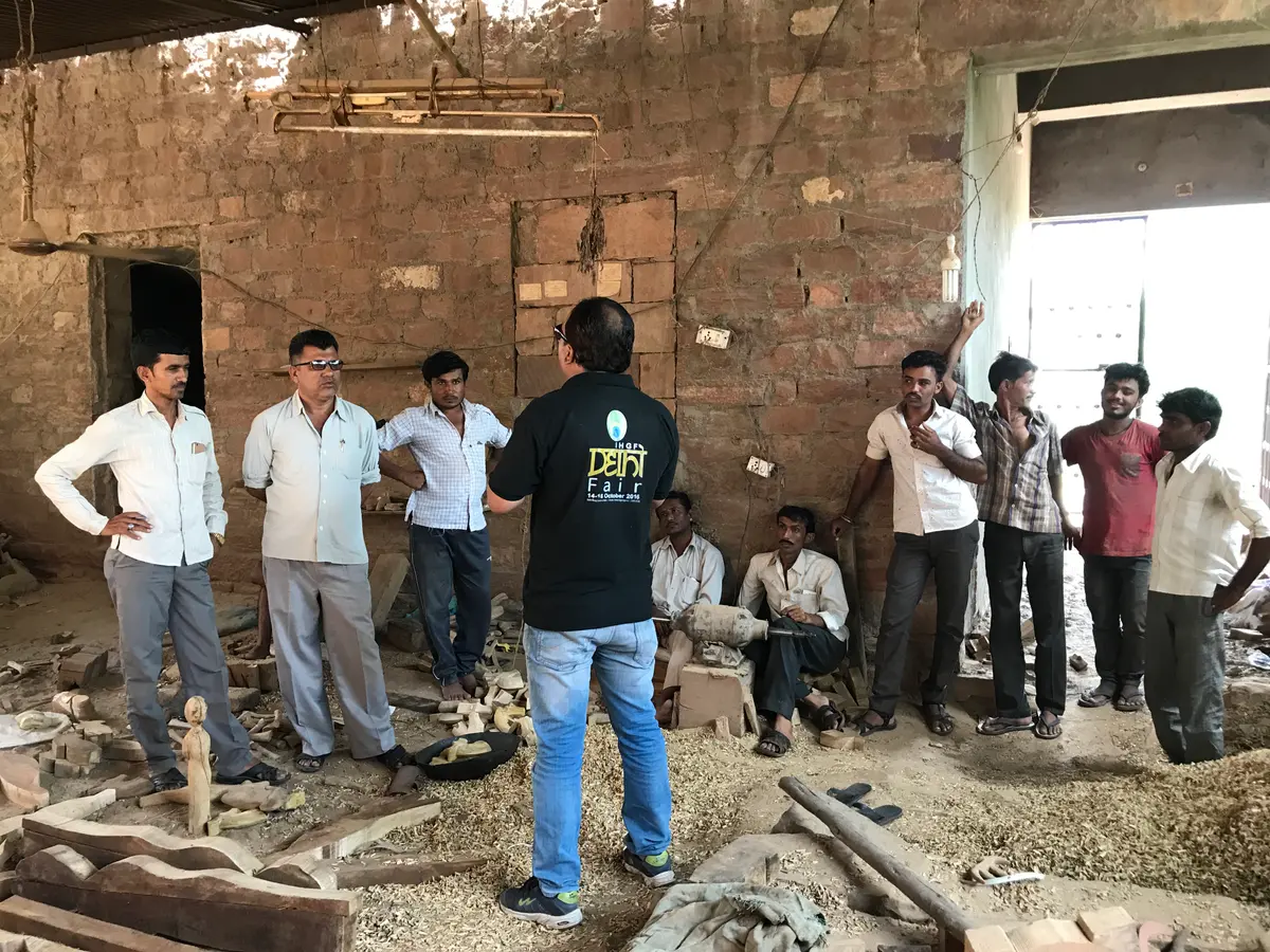 Inside a wood-carving workshop — artisans at work amid the shavings.