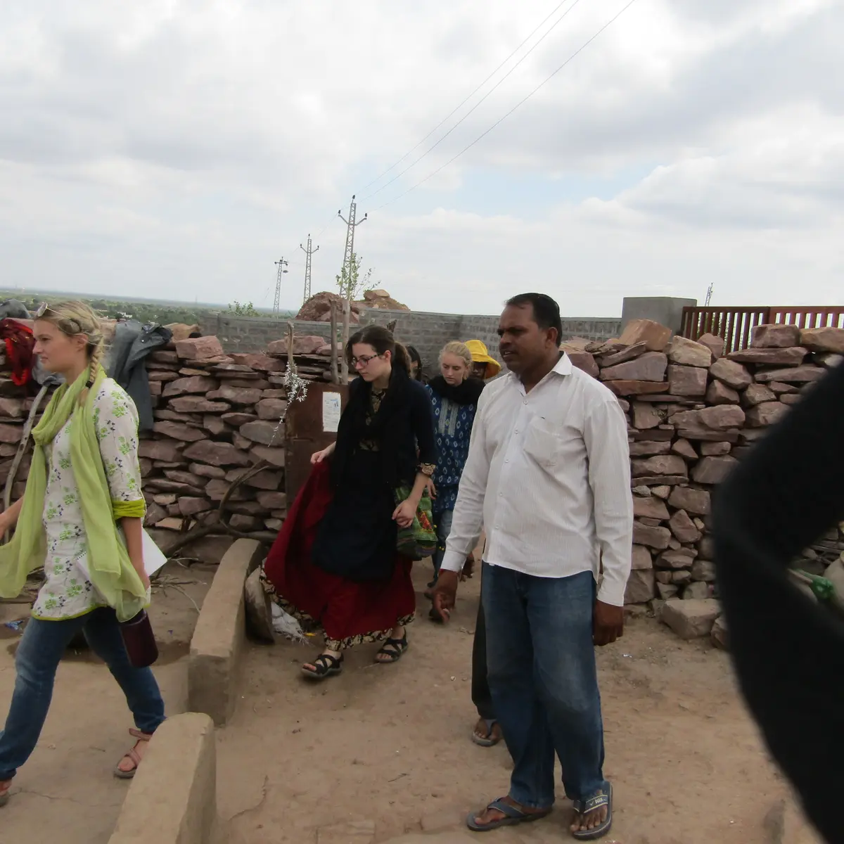 A foreign delegation touring the settlement with a UJAS field worker.