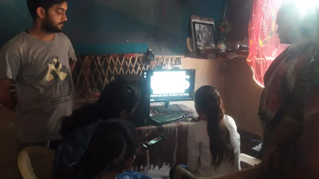A digital literacy session, teaching basic computer skills inside the settlement.