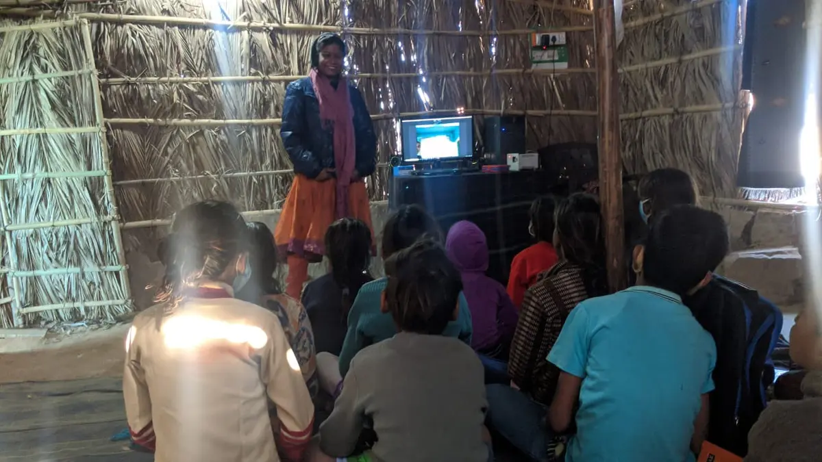 A health awareness video screened for children inside the settlement.